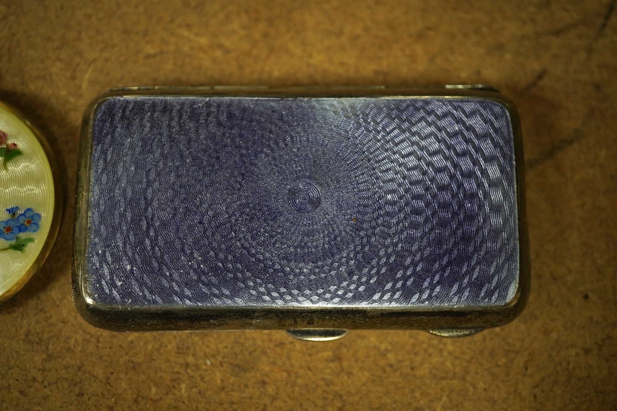 A George V silver and guilloche enamel cigarette case, Henry Clifford Davis, Birmingham, 1917, 84mm, together with a silver and enamel circular compact. Condition - fair